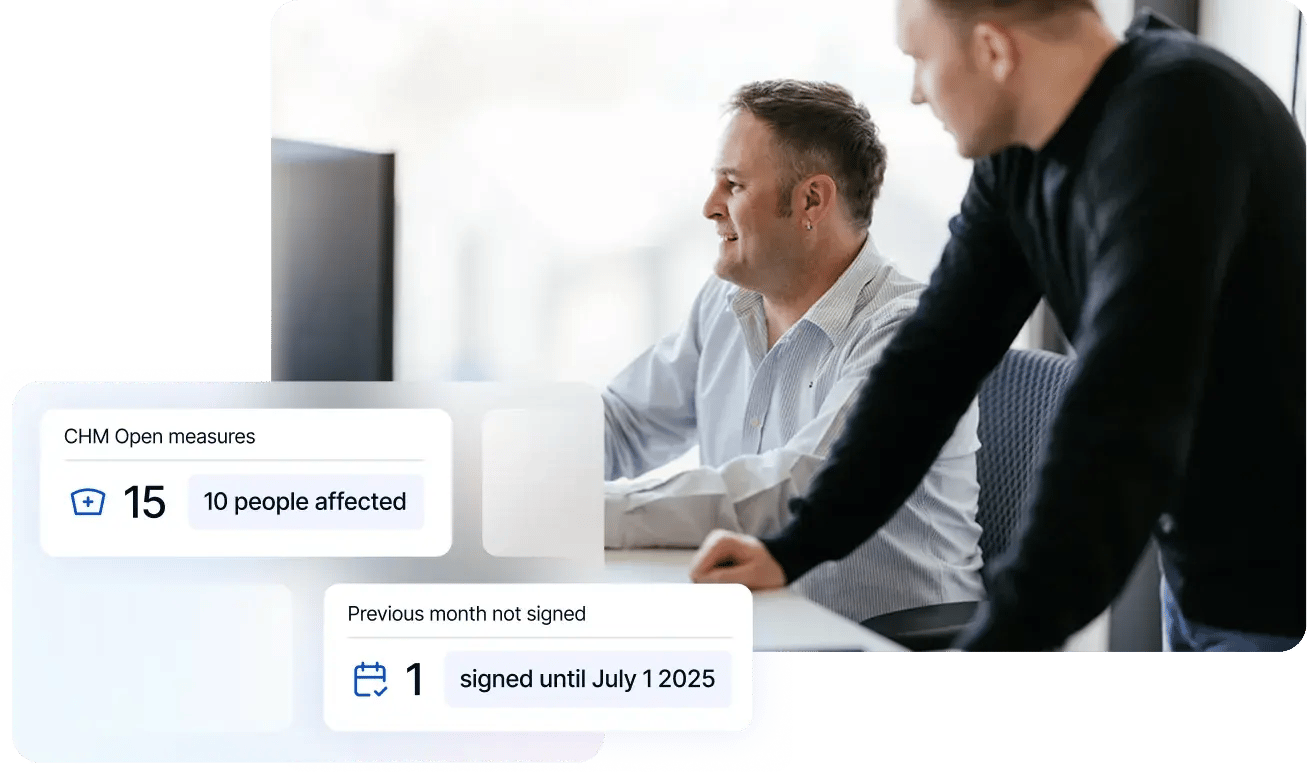 two men at a desk with a computer